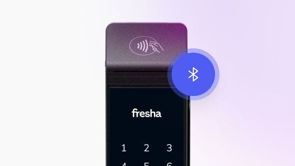 A Fresha card terminal connected to a Bluetooth docking station.