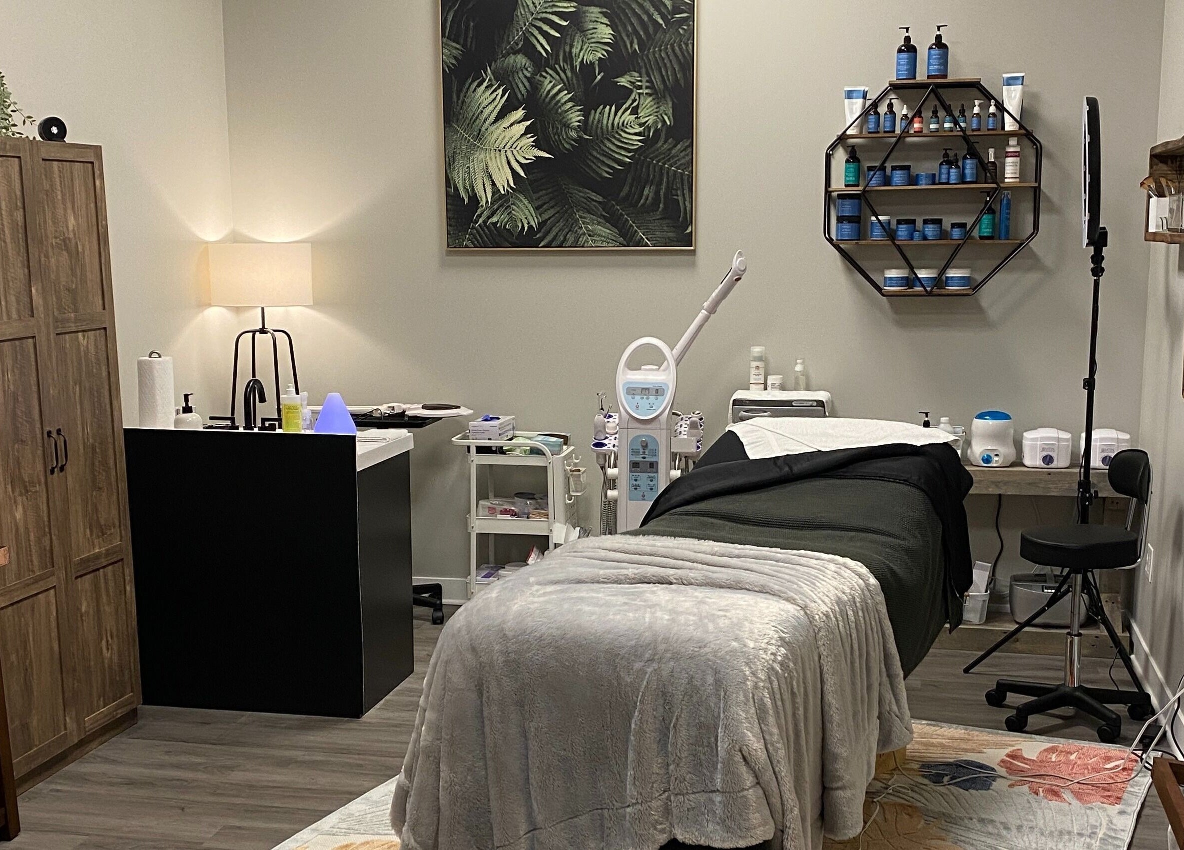 Cozy treatment room at Refined Esthetics in Dekalb, Illinois, US, featuring modern equipment and serene decor.