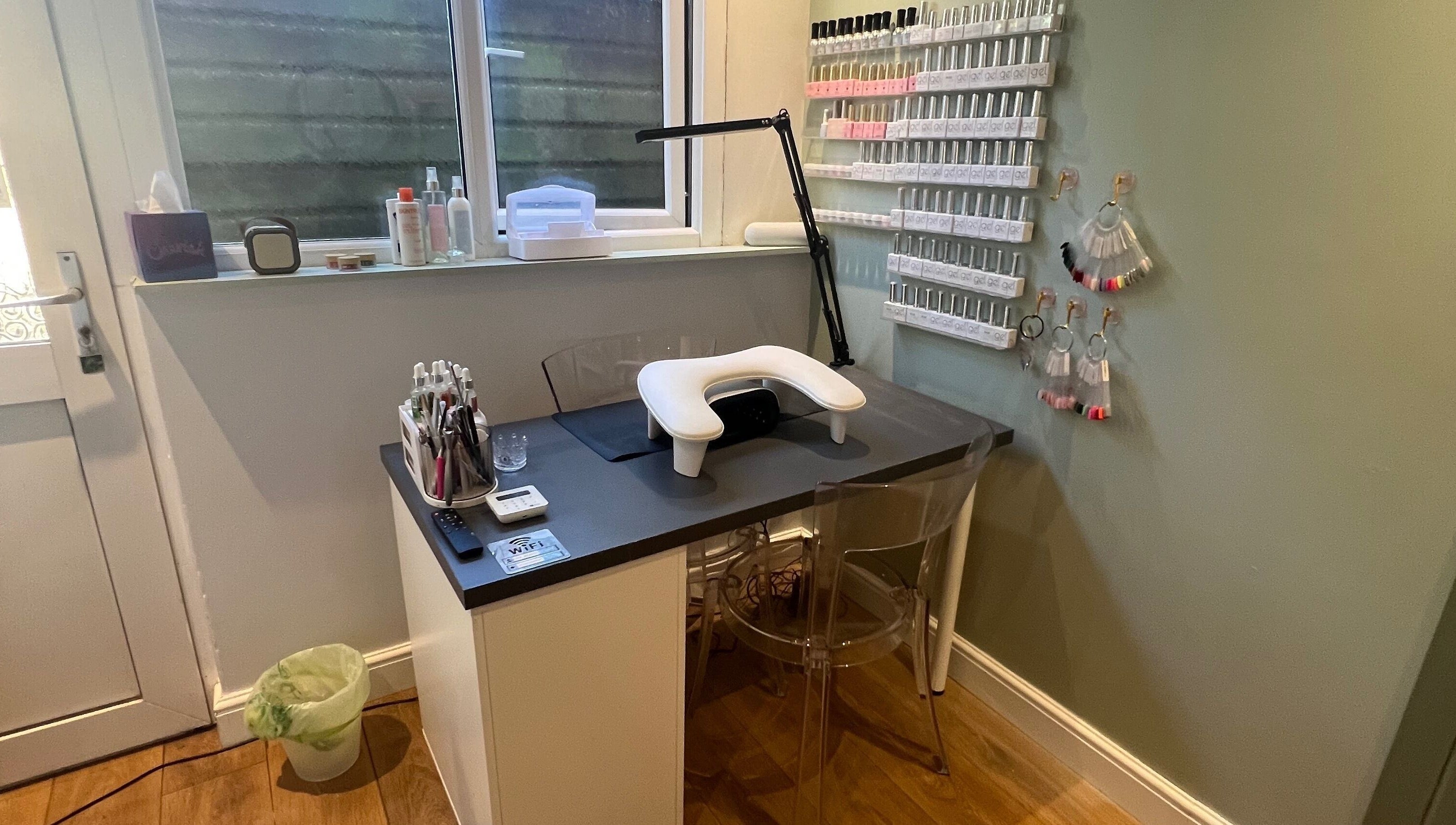 Cozy nail station at Sage Beauty, Highworth, England, GB with organized polish display and modern decor.
