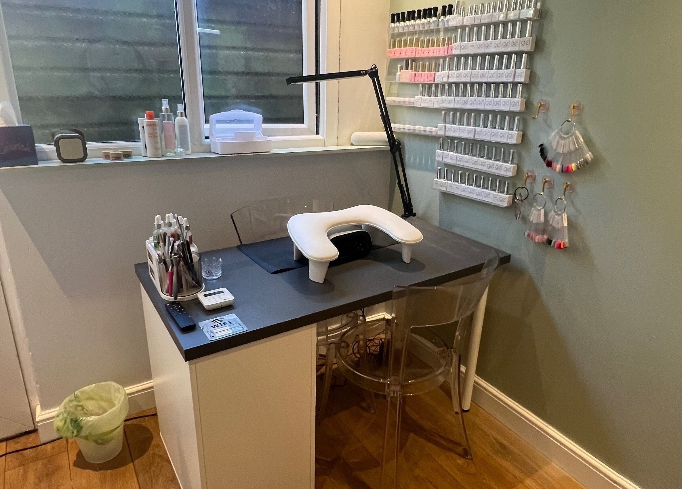 Cozy nail station at Sage Beauty, Highworth, England, GB with organized polish display and modern decor.