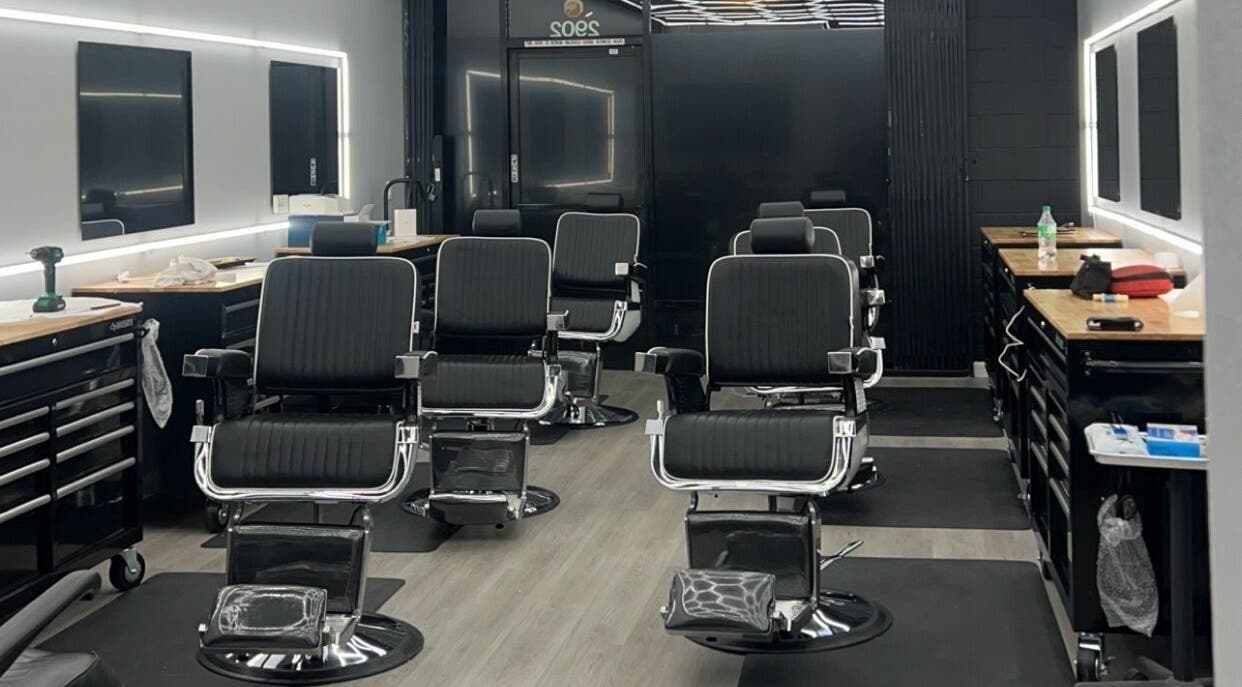 Modern barber chairs in a sleek setup at FBB Barbershop, Los Angeles, California, US.