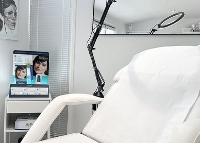 Clean and modern treatment room at Sknject, Rotherham, England, GB with a white chair and specialized equipment.
