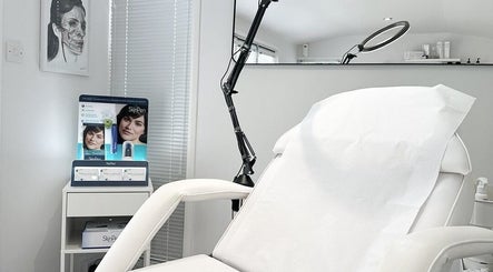 Clean and modern treatment room at Sknject, Rotherham, England, GB with a white chair and specialized equipment.