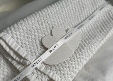 Luxurious white towels at Sknject, Rotherham, England, GB, showcasing premium spa experience.