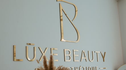 Lūxe Beauty Spa & Esthétique logo in gold, Clarence-Rockland, Ontario, CA enhancing wall decor.
