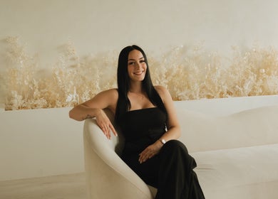 Relaxed woman in chic black attire at Lūxe Beauty Spa & Esthétique, Clarence-rockland, Ontario, CA.
