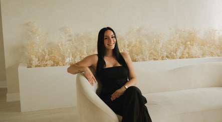 Relaxed woman in chic black attire at Lūxe Beauty Spa & Esthétique, Clarence-rockland, Ontario, CA.