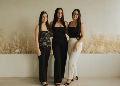 Three staff members at Lūxe Beauty Spa & Esthétique in Clarence-rockland, Ontario, CA, pose elegantly.