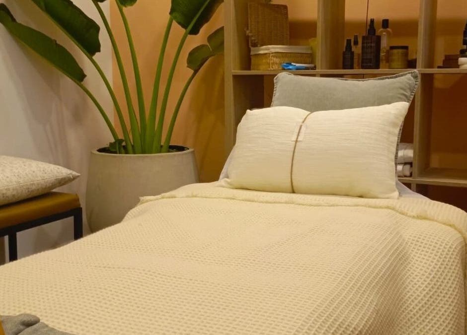 Cozy spa bed at Spa Spacio, Medellín, Antioquia, CO with plush pillows and serene decor.