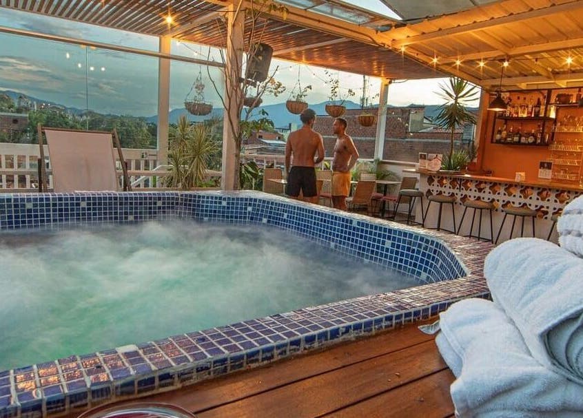 Rooftop jacuzzi at Spa Spacio, Medellín, Antioquia, CO offers serene city views with cozy seating areas.