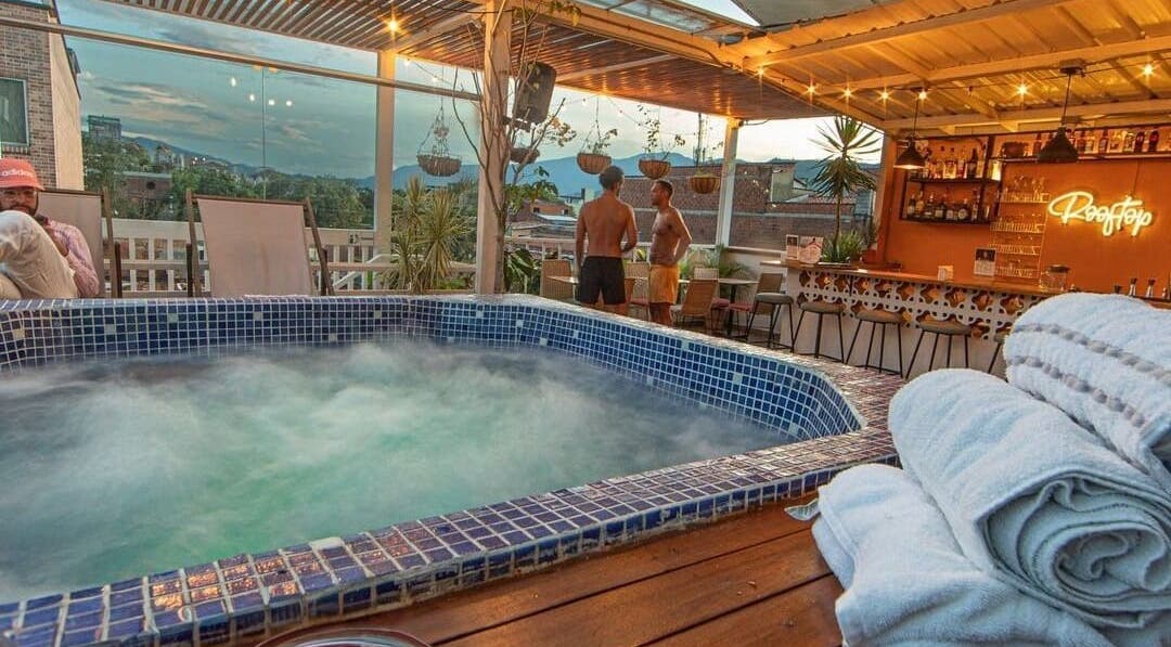 Rooftop jacuzzi at Spa Spacio, Medellín, Antioquia, CO offers serene city views with cozy seating areas.
