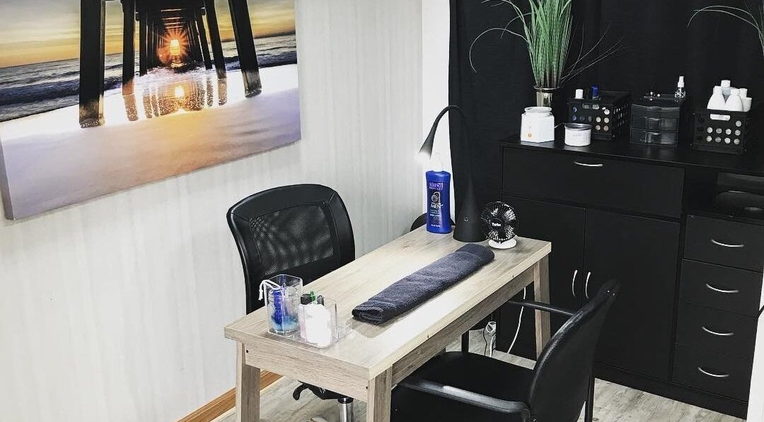 Tranquil manicure station at Jstyles, Lincoln Park, Michigan, US with elegant decor and sunset art.