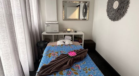 Serene massage room at Soothe & Soul. Waiuku Thai Massage Therapy, Auckland, NZ with floral decor.