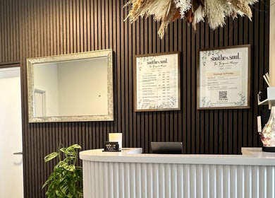 Reception area at Soothe & Soul. Waiuku Thai Massage Therapy, Auckland, NZ, with elegant decor and menu display.
