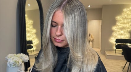Woman with sleek hair at Mane Muse salon in Pendlebury, England, GB.