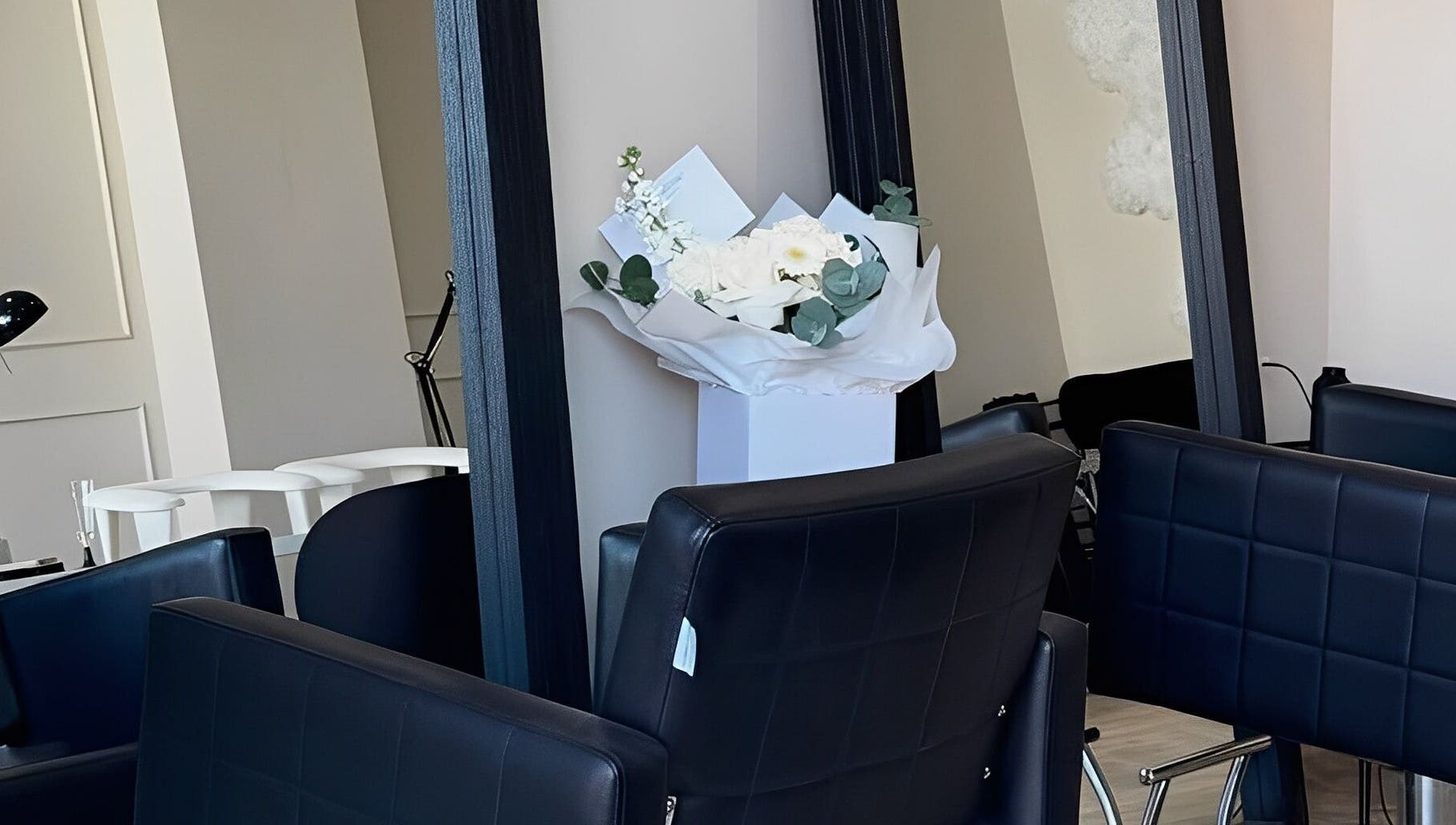 Modern salon chairs and mirrors at Mane Muse in Pendlebury, England, GB with elegant decor.