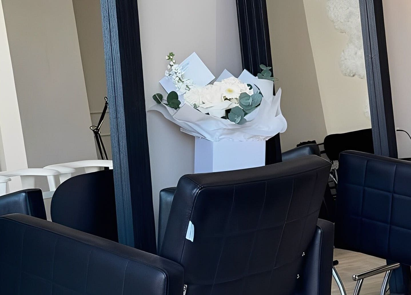 Modern salon chairs and mirrors at Mane Muse in Pendlebury, England, GB with elegant decor.