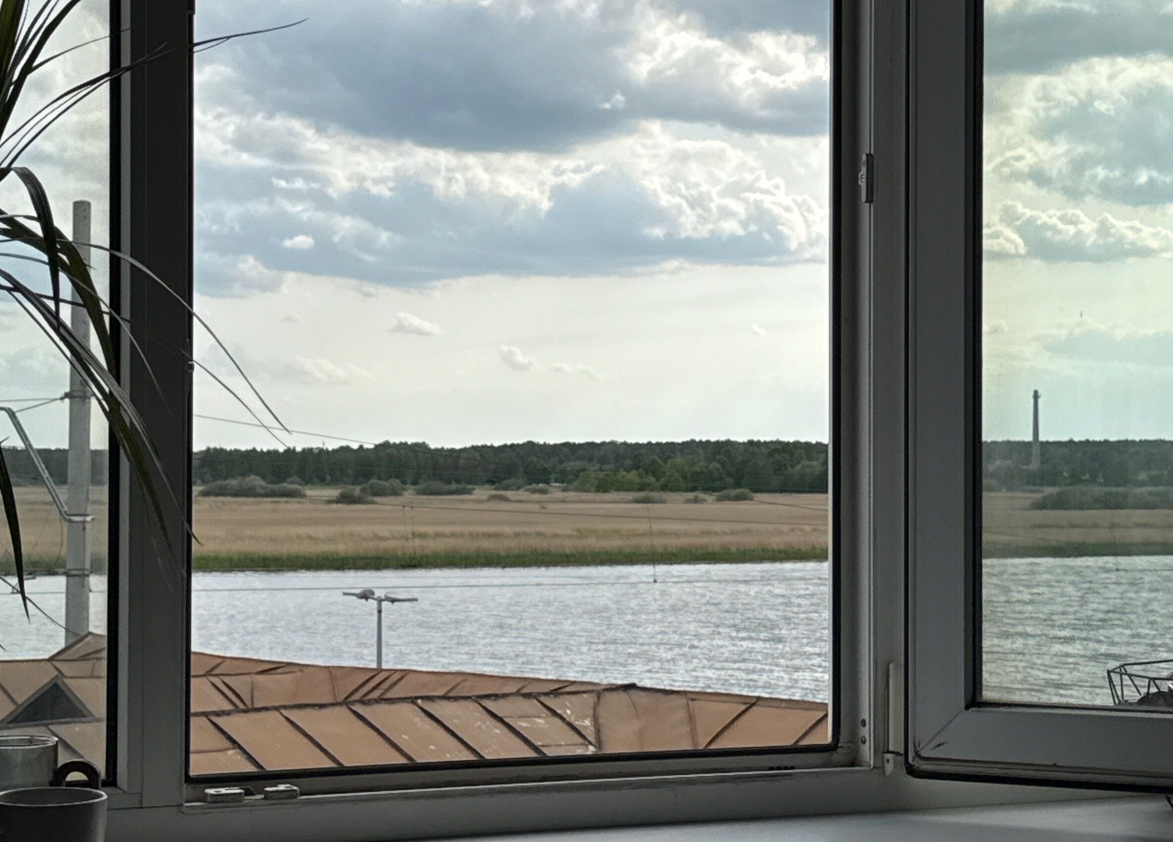 Calm river and trees seen through Adelenailsstudio window, Jūrmala, Latvija, LV.