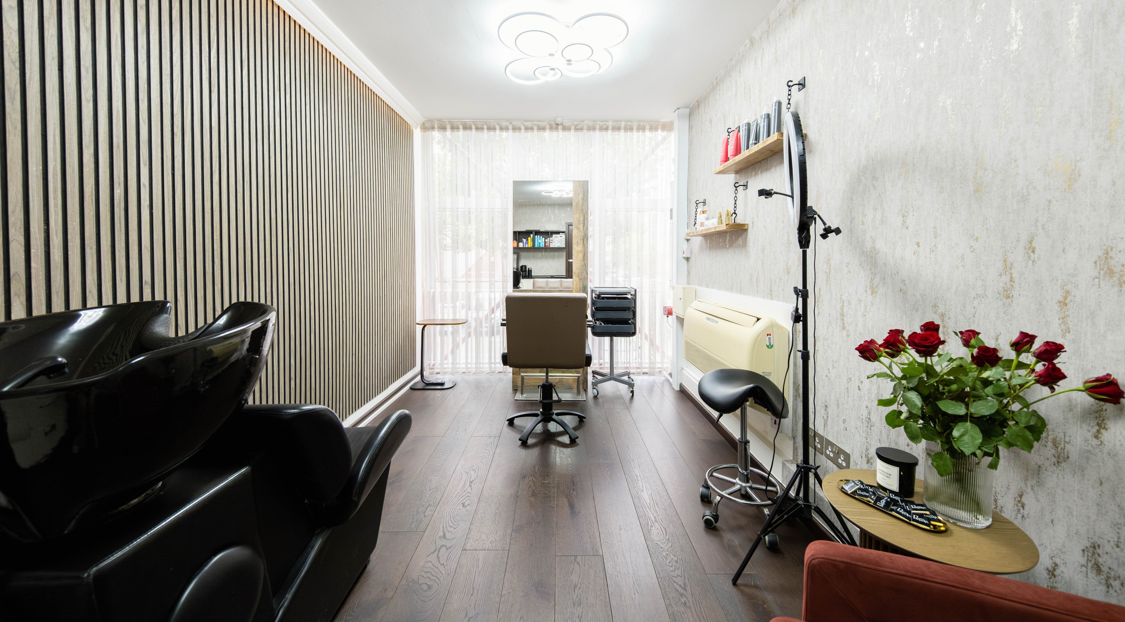 Modern styling chair and wash station at Potapovs Hair, London, England, GB, showcasing sleek design.