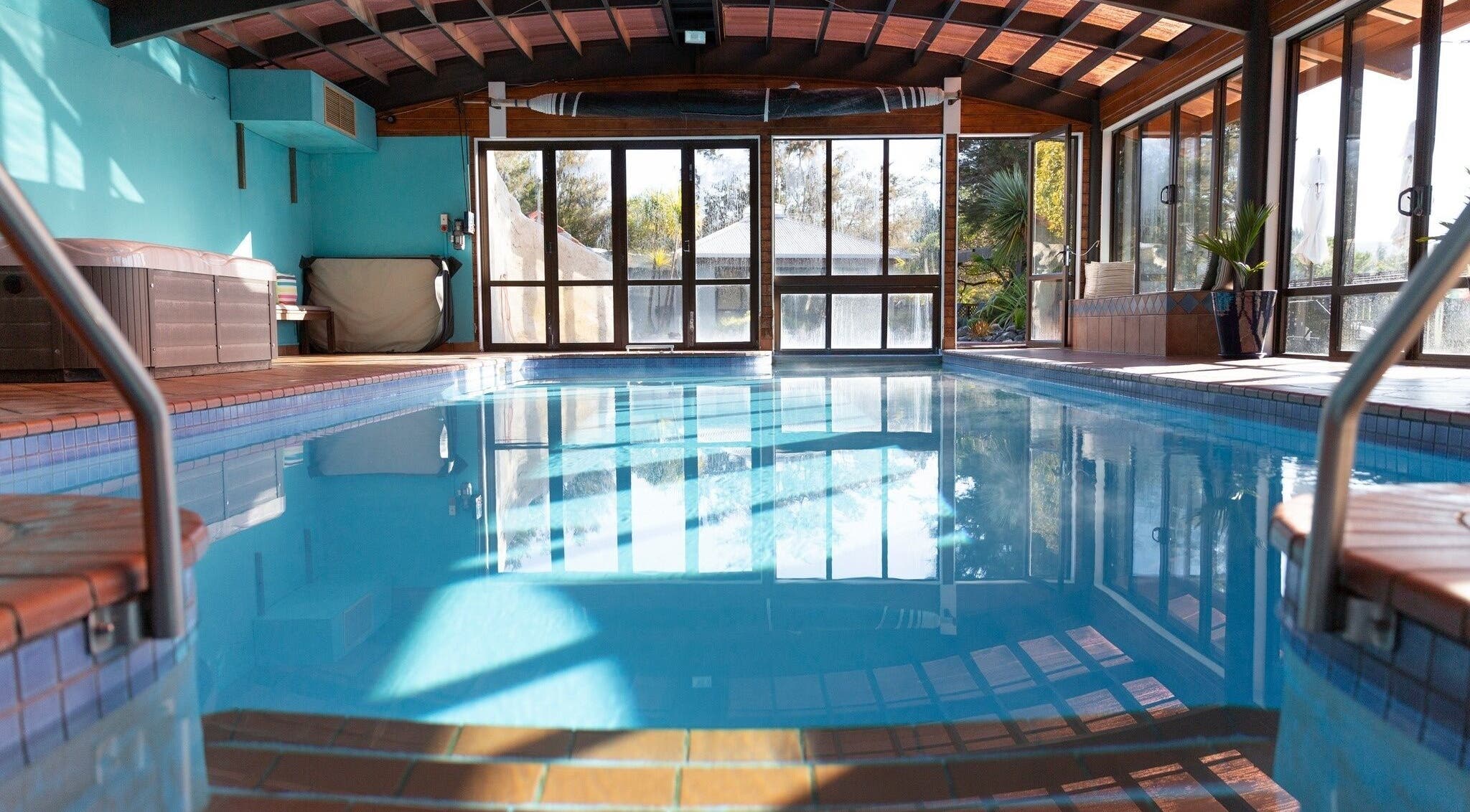 Indoor pool with serene views at Kimi Ora Day Spa, Kaiteriteri, Tasman, NZ, featuring natural light and relaxation.