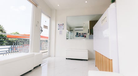 Bright interior of Jinsei Massage - Pila Branch in Pila, Calabarzon, PH with white seating and a large window.