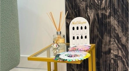 Nail polish samples and diffuser on a gold table at Biab Nails Balham in London, England, GB.