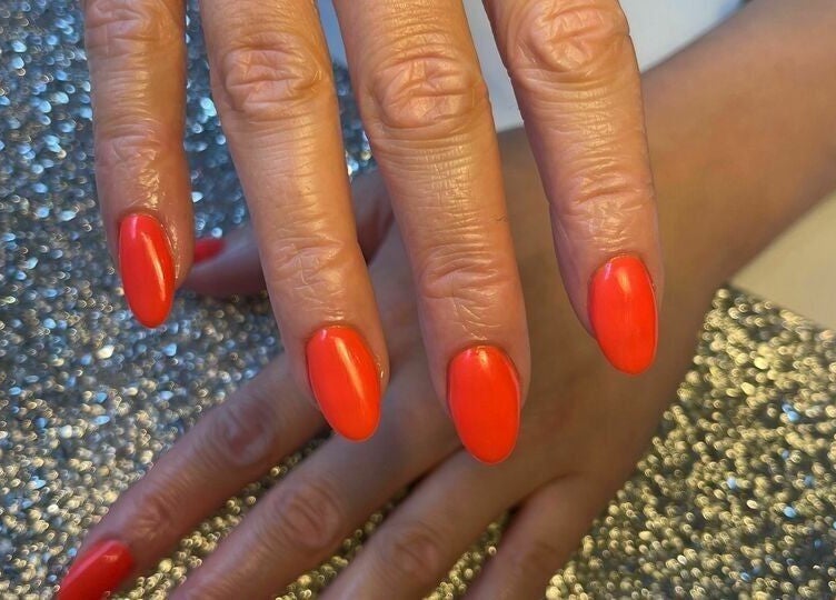 Radiant crimson nails at Biab Nails Balham, London, England, GB, showcasing elegant manicure.