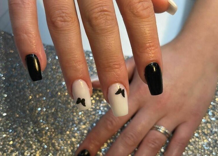 Elegant black and white nail design at Biab Nails Balham, London, England, GB, featuring butterfly art.