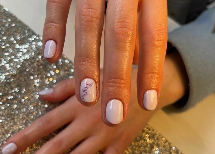 Elegant white manicure with nail art at Biab Nails Balham, London, England, GB.