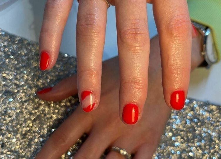 Red manicured nails with glitter at Biab Nails Balham, London, England, GB.
