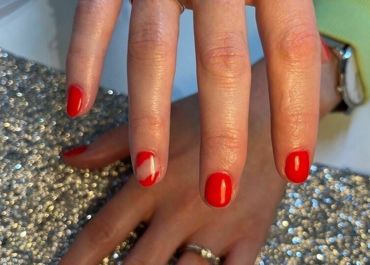 Red manicured nails with glitter at Biab Nails Balham, London, England, GB.