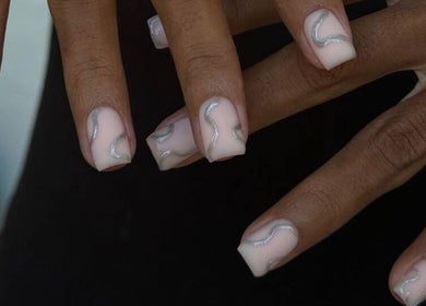 Stylish nail art with silver waves at Sadiou's Lab, Bali, ID, showcasing chic manicure style.