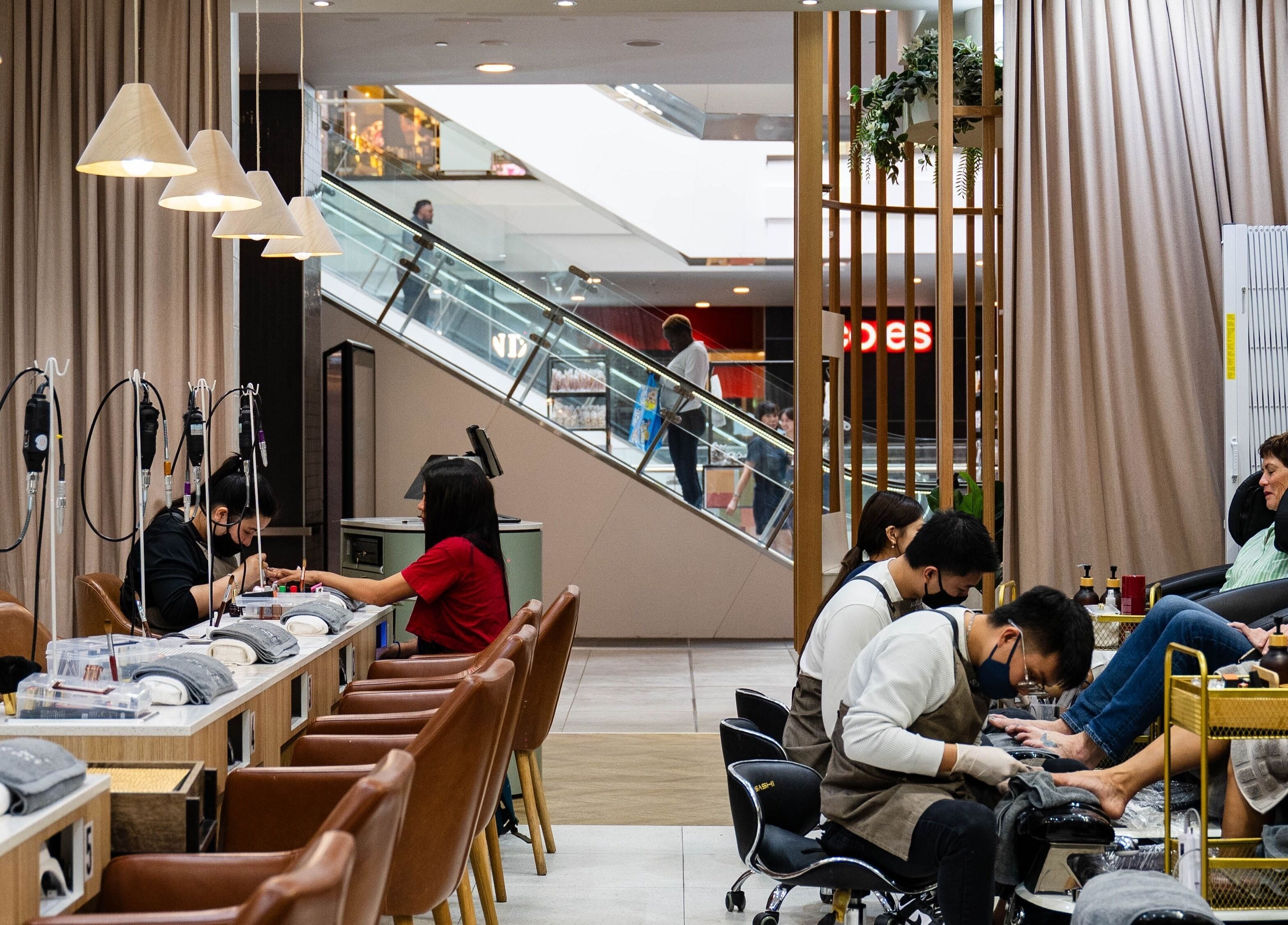 Inside The Nail Bar By Creative Claws in Indooroopilly, Queensland, AU, people enjoy relaxing manicures and pedicures.