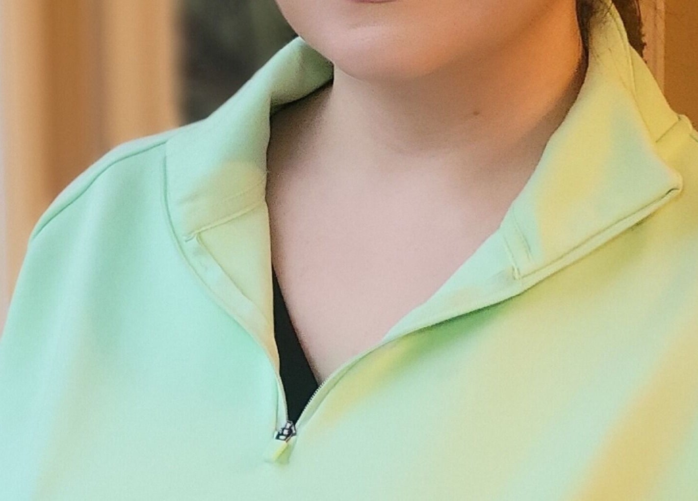 A relaxed individual wearing a pastel green top at Pink & Pampered Salon, Chicago, Illinois, US.