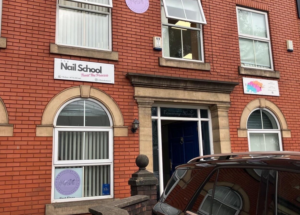 The Nail School facade at Middleton, England, GB with its welcoming entrance and red brick exterior.
