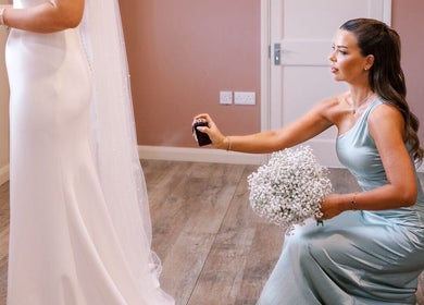 Bridesmaid assisting at G L O Y À, Rochester, England, with flower and spray detail.