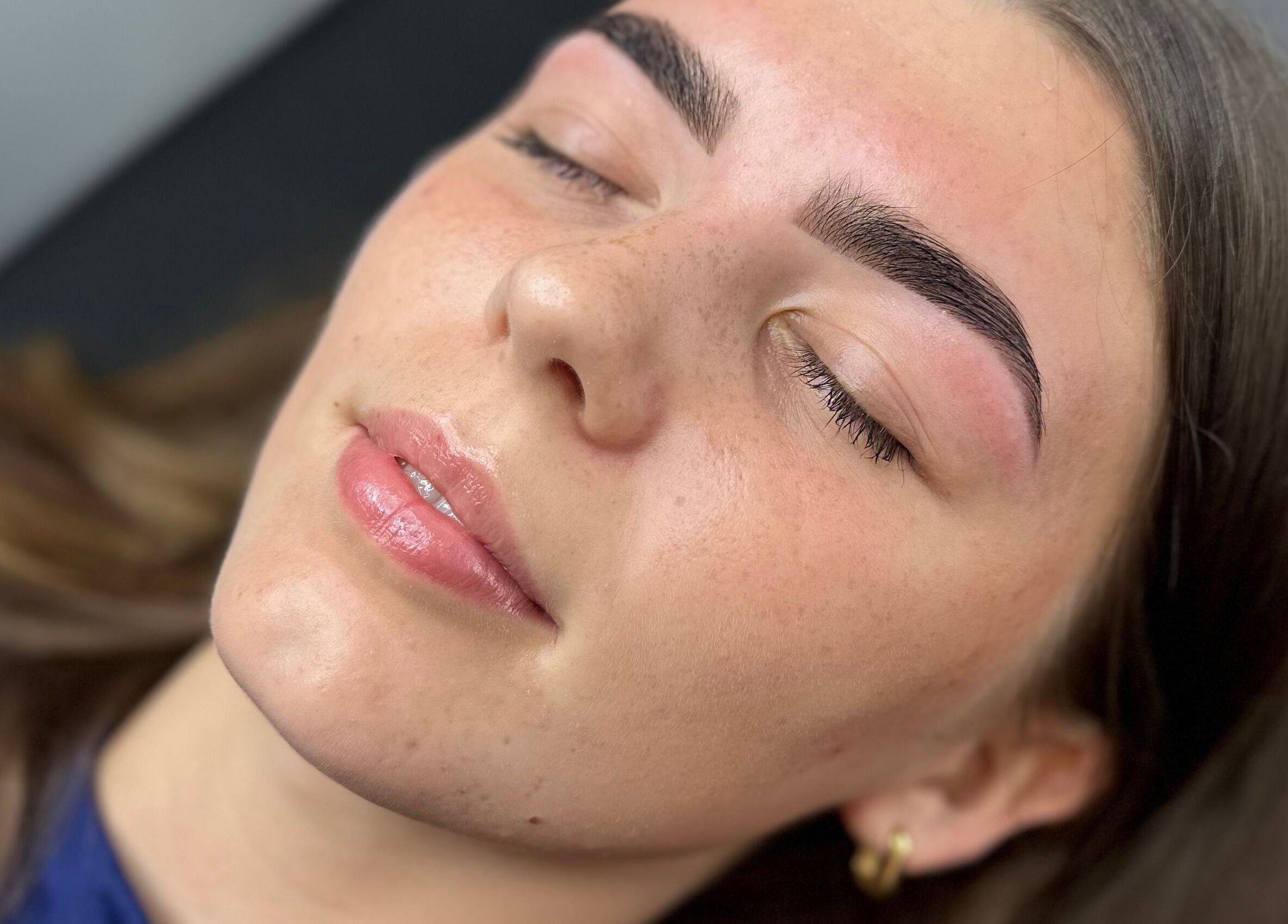 Close-up of a serene face with perfect eyebrows at G L O Y À, Rochester, England, GB.