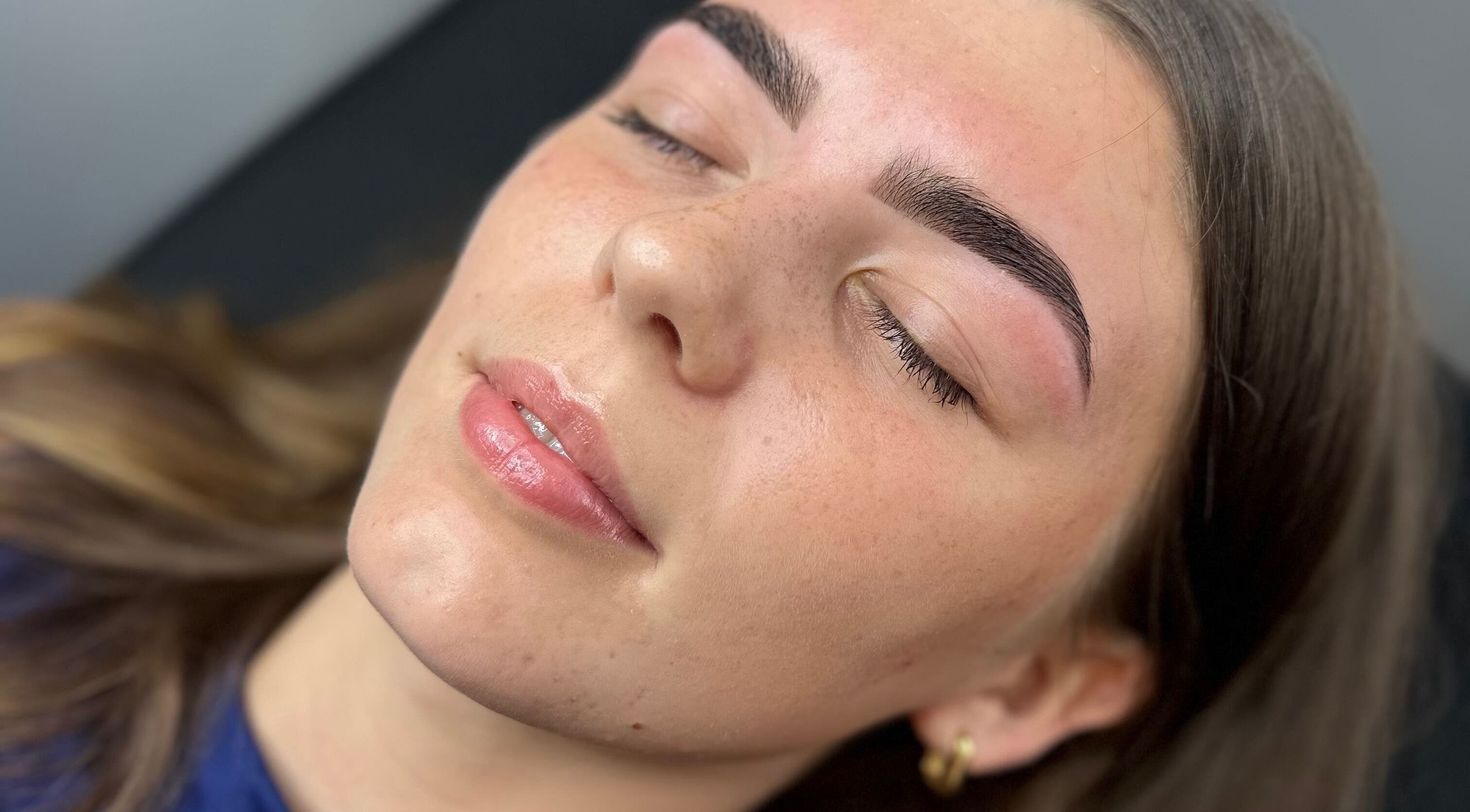Close-up of a serene face with perfect eyebrows at G L O Y À, Rochester, England, GB.