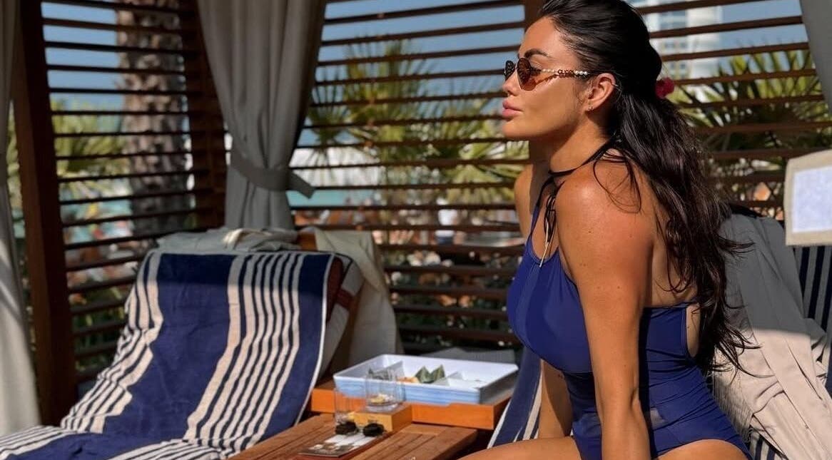 Woman in swimwear relaxing at a luxurious cabana at G L O Y À, Rochester, England, GB.