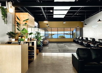 Stylish interior of Recovery Room Kawana Waters with plush seating, natural light, and ocean view in Bokarina, Queensland, AU.
