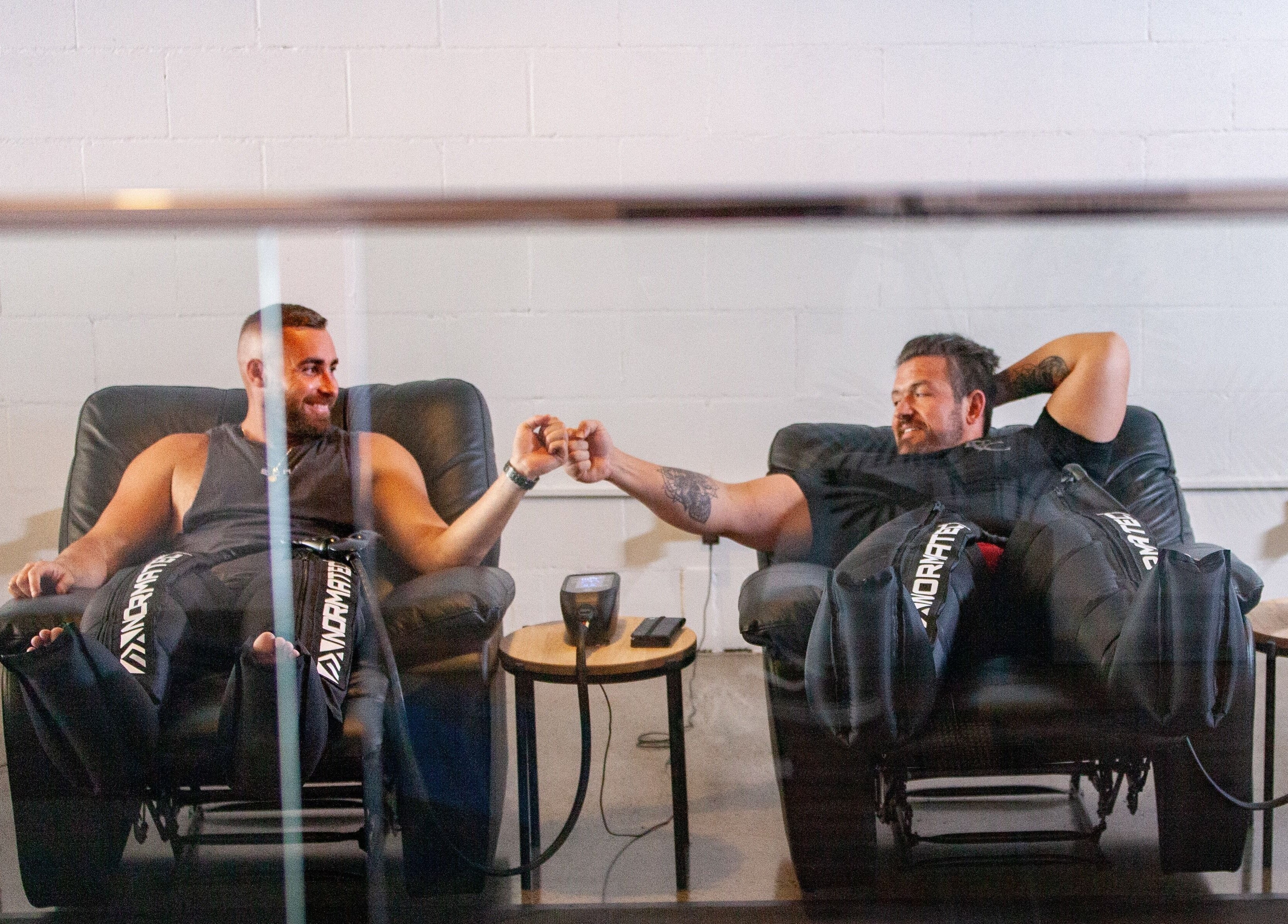 Two men relaxing with therapy at Recovery Room Kawana Waters, Bokarina, Queensland, AU.