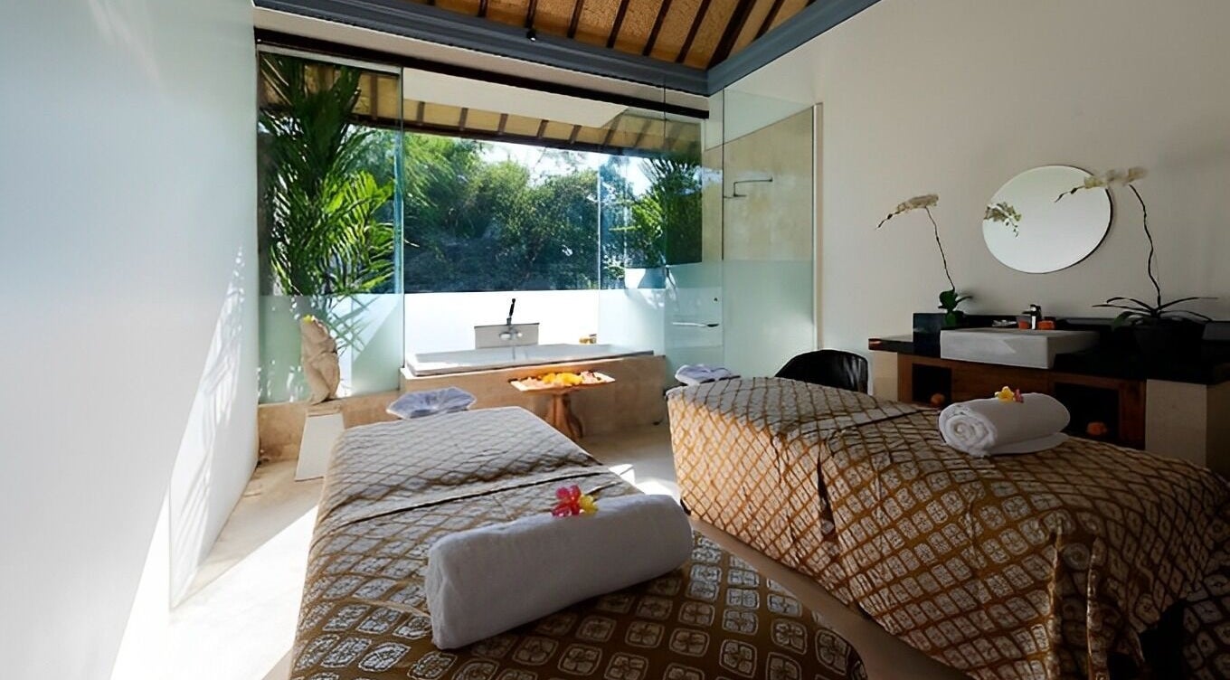 Serene treatment room at Jivana Spa, Bali, Bali, ID with lush garden view, inviting tranquility.