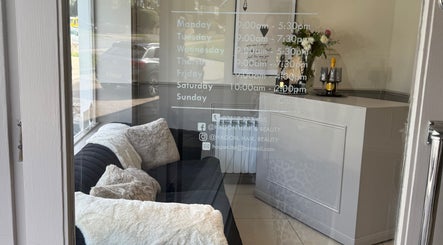 Cozy seating area at Hagon Hair & Beauty Ltd in Brighton And Hove, England, GB with opening hours displayed.