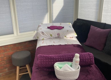 Cozy treatment room at Sarah Sharp Massage, Copmanthorpe, England, with plush decor and massage essentials.