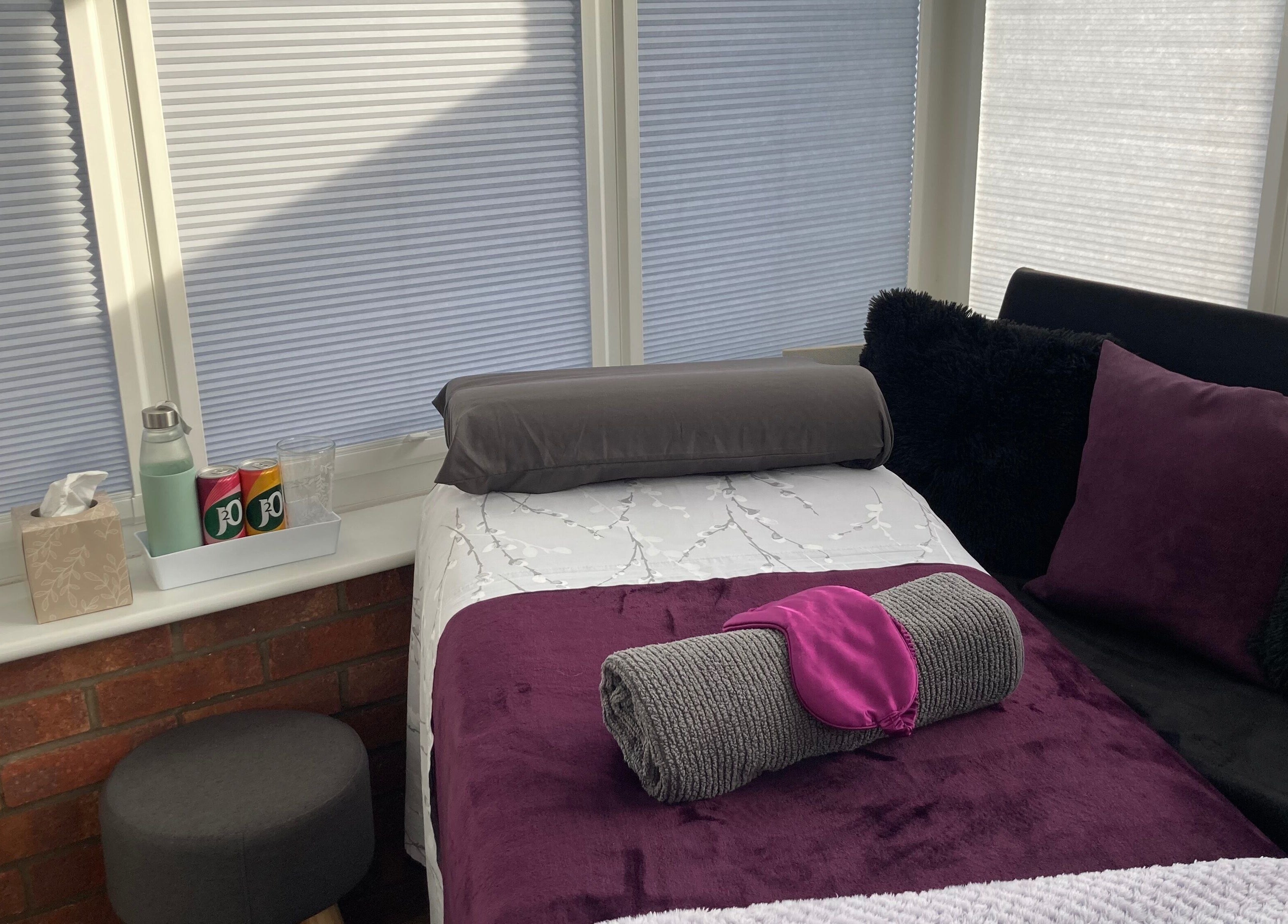 Cozy massage room at Sarah Sharp Massage in Copmanthorpe, England, GB, with plush bedding and tranquil ambiance.