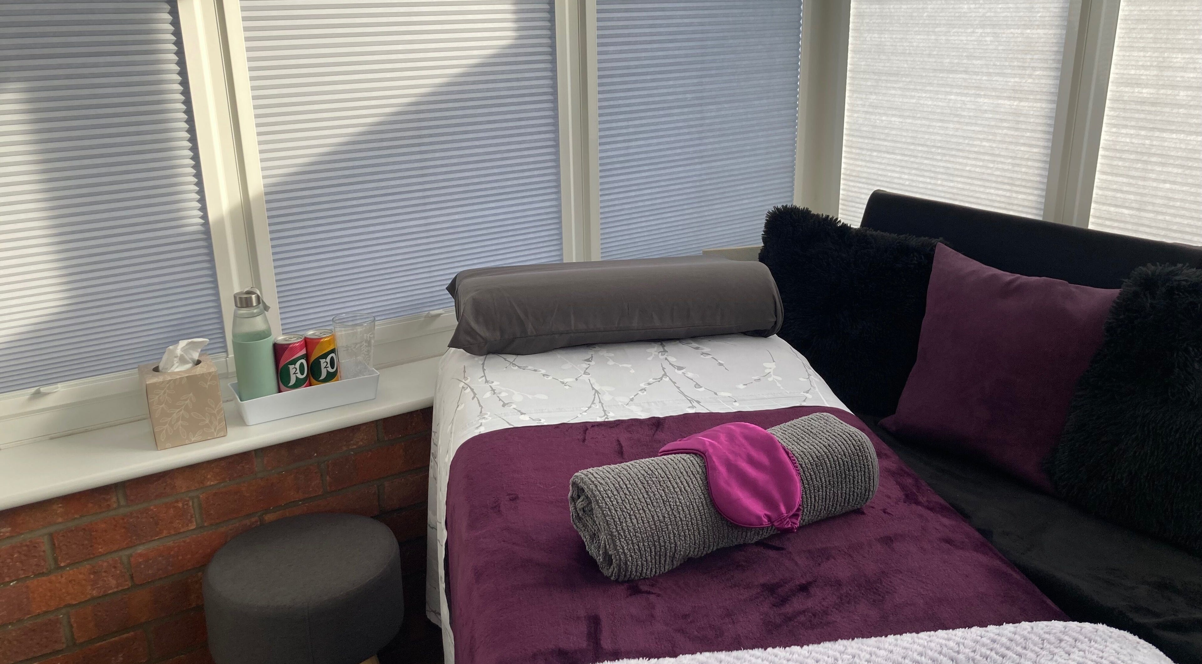 Cozy massage room at Sarah Sharp Massage in Copmanthorpe, England, GB, with plush bedding and tranquil ambiance.