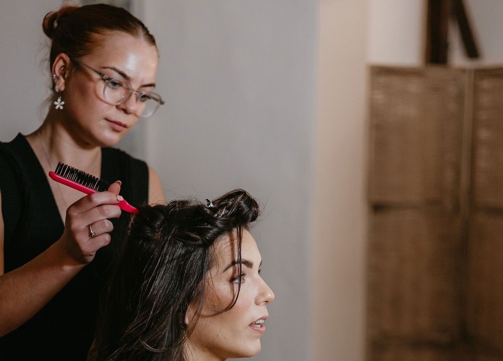 Stylist working on a client's hair at Niamh Elizabeth Hairdressing, Preston, England, GB.