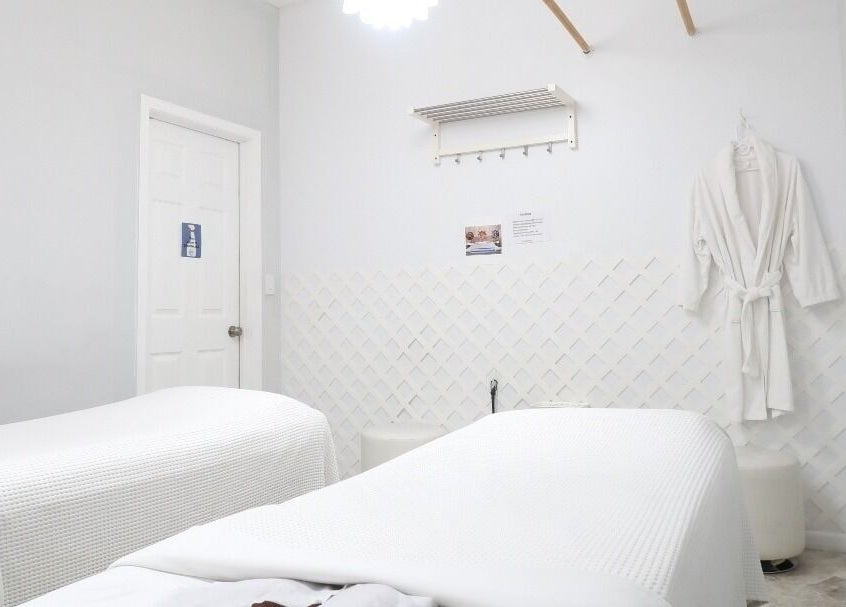 Calm massage room at Mongolian MassageLAB Skokie, Skokie, Illinois, US with two massage tables and robes.