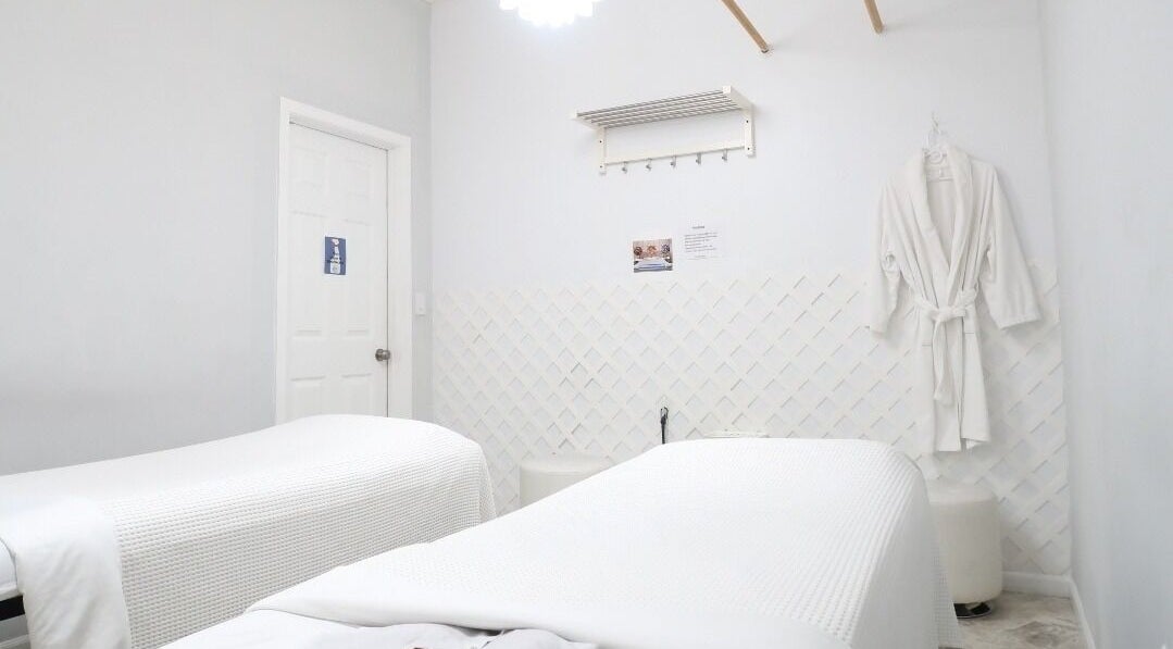 Calm massage room at Mongolian MassageLAB Skokie, Skokie, Illinois, US with two massage tables and robes.