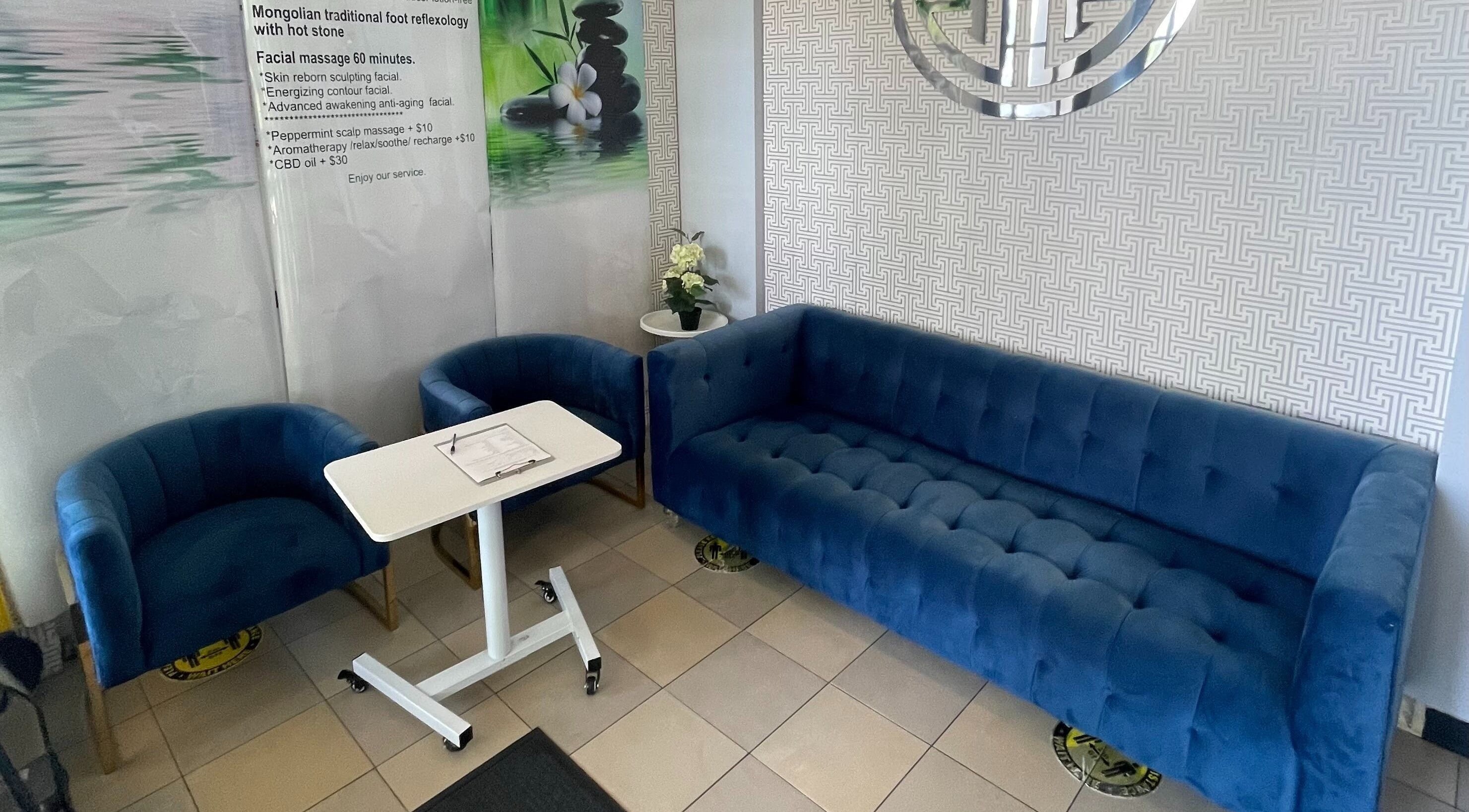 Elegant waiting area with blue sofas at Mongolian MassageLAB Skokie, Skokie, Illinois, US welcoming guests.